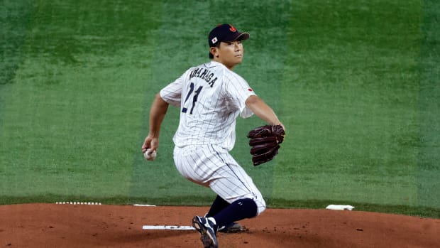 Mar 21, 2023; Miami, Florida, USA; Japan starting pitcher Shota Imanaga (21) pitches against the USA in the first inning at LoanDepot Park. Mandatory Credit: Rhona Wise-USA TODAY Sports